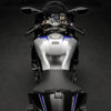 2025 Yamaha YZF-R1M motorcycle. Silver fuel tank with blue accents, black seat, handlebars, and mirrors.