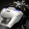 2025 Yamaha YZF-R1M close-up of the silver fuel tank with blue accents and the fuel cap.