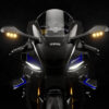Front view of the 2025 Yamaha YZF-R1M sportbike. Features carbon fiber fairings, LED headlights, and mirror-mounted turn signals.