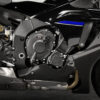 2025 Yamaha YZF-R1M engine detail. Close-up of the motor, carbon fiber fairing, and exhaust.