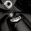 Close-up of the 2025 Yamaha YZF-R1M motorcycle featuring the R1M logo and a unique serial number on a black surface.