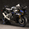 2025 Yamaha YZF-R1M sportbike. Black and blue color scheme, carbon fiber accents, and high-performance features.