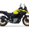 The SUZUKI V-STROM 650XT, featuring a yellow and black color scheme, windscreen, large exhaust, spoked wheels, and visible rear suspension, is displayed from the left side against a white background.