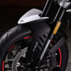 Close-up of a CFMOTO 800NK SPORT motorcycle front wheel featuring an ABS brake system, visible tire tread, and bold red rim accents against a dark background.