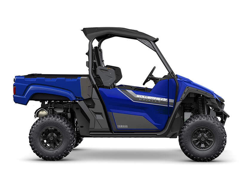 Side view of the YAMAHA WOLVERINE X2 UTILITY, featuring a blue and black design with a roll cage and off-road tires.