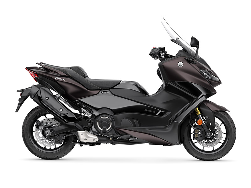 A sleek YAMAHA TMAX 560 - 2024 motorcycle, with modern design and visible details like the seat, exhaust, and handlebars, displayed on a plain white background.