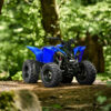 A YAMAHA YZF50 2025 all-terrain vehicle, in blue, is parked on a dirt path amidst a lush green forest.
