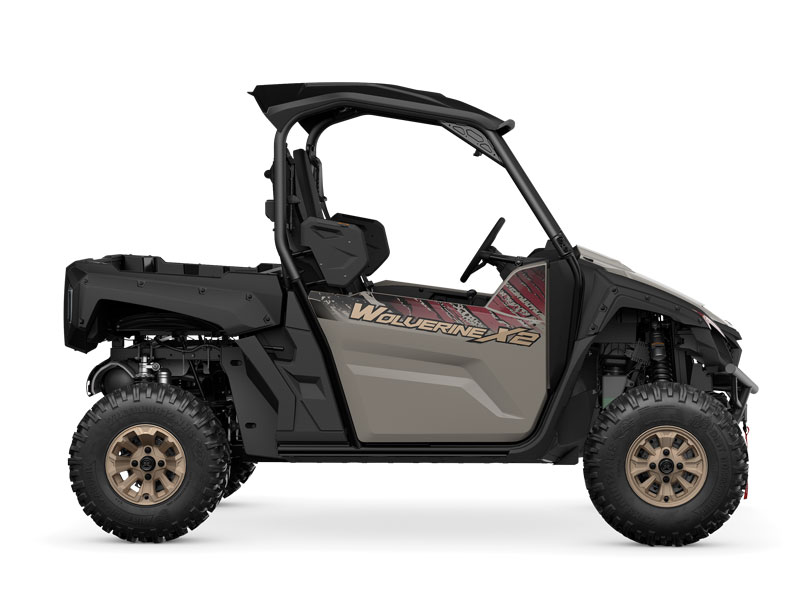 Side view of the YAMAHA WOLVERINE X2 XT-R, an off-road utility vehicle with an open cabin and large wheels, displayed against a white background.