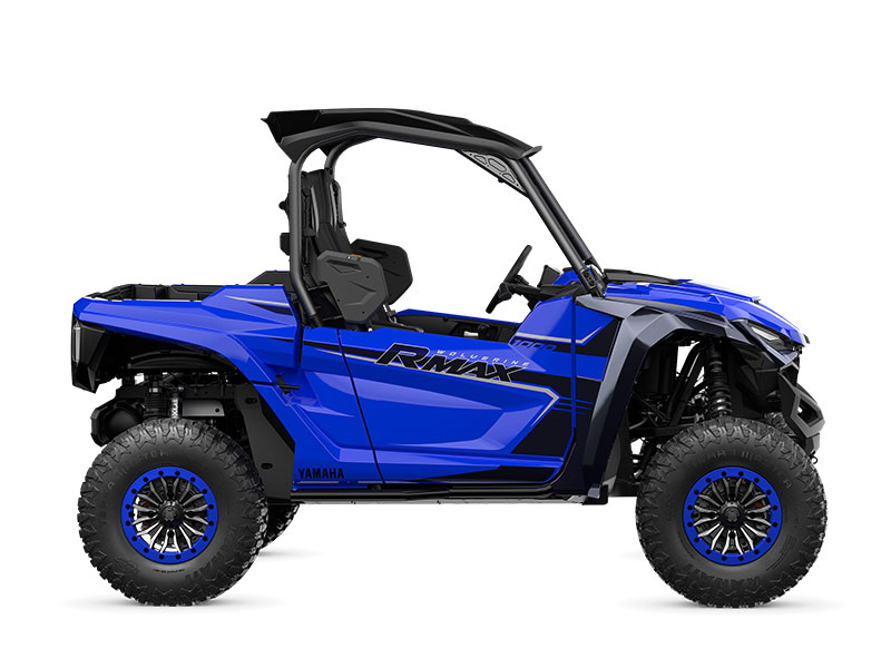 A blue YAMAHA WOLVERINE RMAX2 1000 SPORT off-road utility vehicle with large tires and open seating for two.