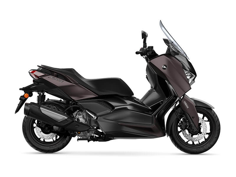 The YAMAHA XMAX 300 LAMS 2025 showcases a sleek, modern design in black, highlighted by its tinted windshield and side profile.