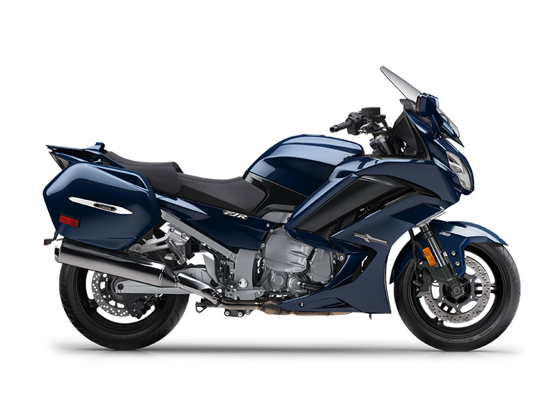 The YAMAHA FJR 1300 2024, a blue touring motorcycle with hard saddlebags, a windshield, and a sleek design, is displayed from the side on a white background.