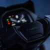 Close-up of a CFMOTO 150SC motorcycle dashboard showcasing the digital display and brand logo against a dark background.