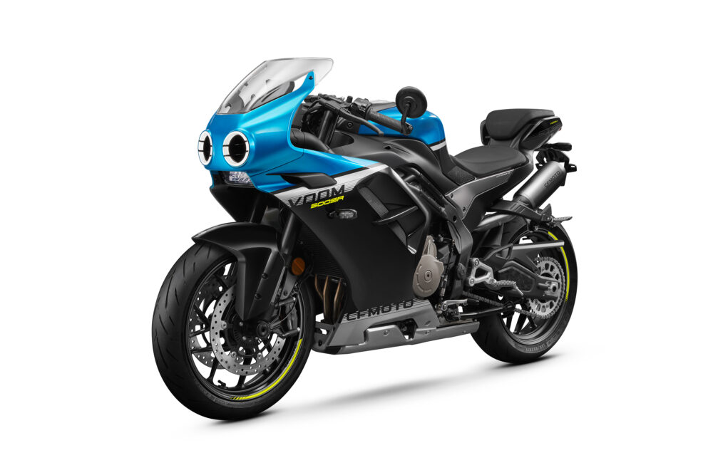 The CFMOTO 500SR VOOM, a blue and black sport motorcycle with dual round headlights, aerodynamic fairings, and yellow accents, is photographed on a white background.