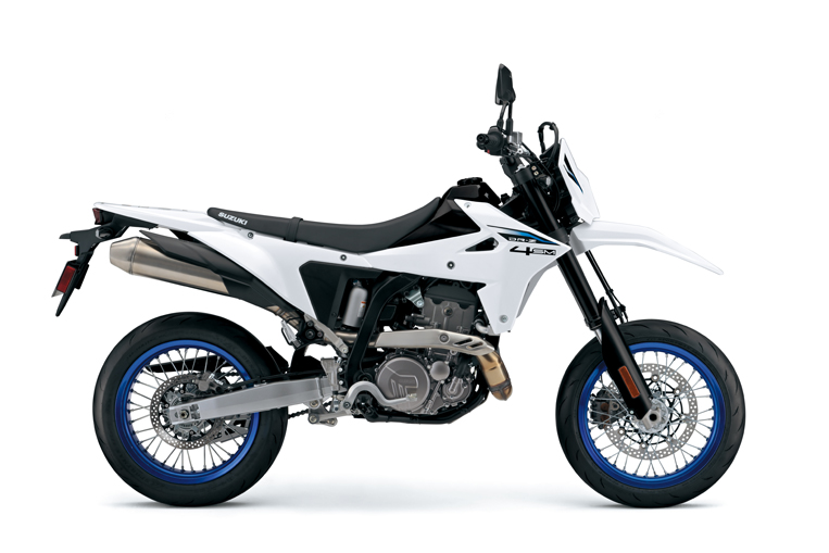 The SUZUKI DR-Z 4SM, a white supermoto motorcycle with blue-rimmed wheels, is displayed in profile against a plain white background.
